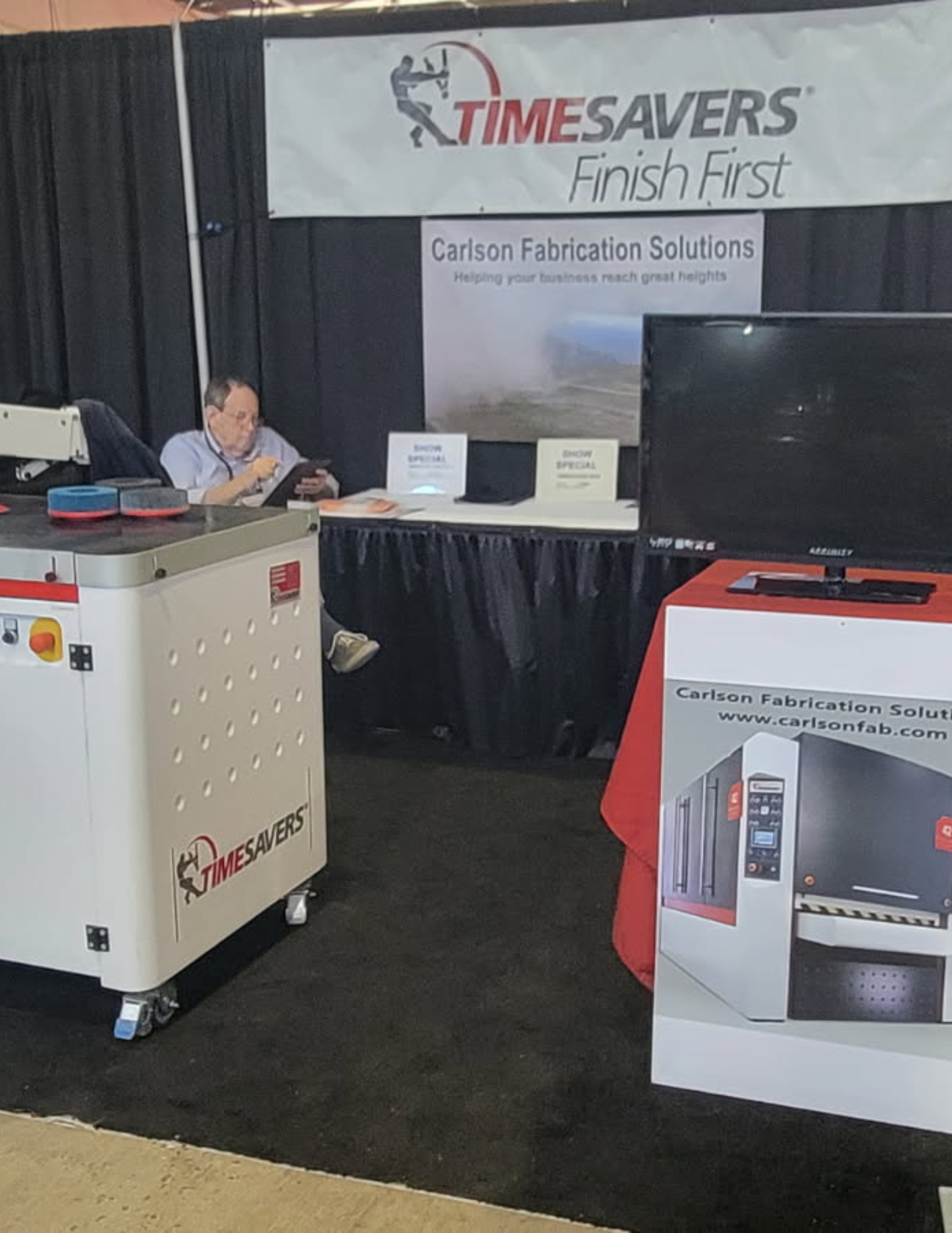 Carlson Fabrication Solutions trade show booth with a Timesavers finishing machine